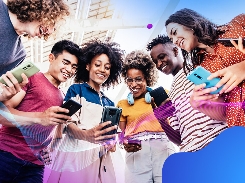 group of people looking in a circle looking down at phones