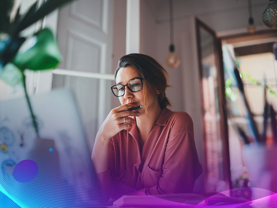 Businesswoman sitting at computer and using a Customer Data Platform to build more audience-based campaigns